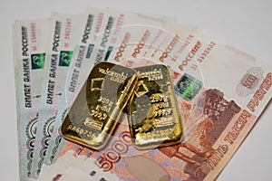 Russian rubles banknotes with gold bullion bars