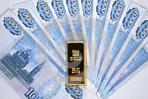 Russian rubles with a gold ingot. Russian financial system backed by gold