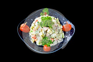 Russian salad olivie on black background side view