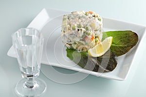 Russian salad with pink salmon and vegetables