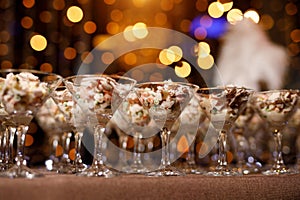 Russian salad in thin-stemmed glass, event catering