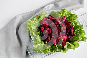 Russian salad vinaigrette on a gray background. Vegetarian dish with beets on a plate