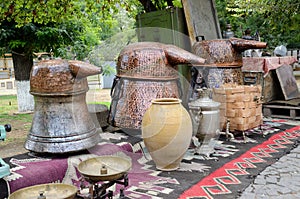 Russian samovar and old copper tanks for making grape vodka