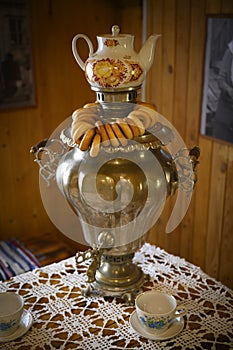 Russian samovar with porcelain cups, teapot and dryers