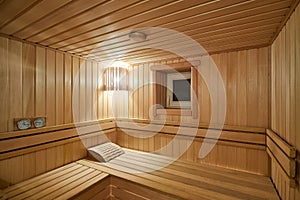 Russian sauna bathhouse with Linden Lining walls and ceiling Abash or African oak bench lanterns hygrometer thermometer