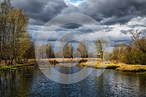 Russian spring landscape with reflections of trees in the lake