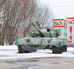 Russian tank in winter against the background of the city photo