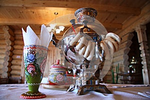 Russian tea drinking with samovar and bread rolls