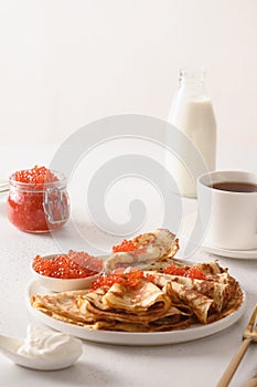 Russian thin pancakes or blini with red caviar.