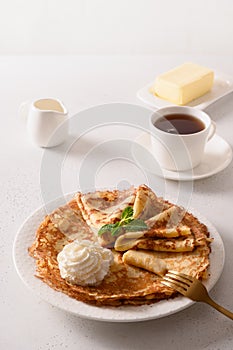 Russian thin pancakes or blini with whipped cream.