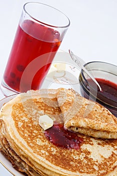 Russian thin pancakes with jam and butter