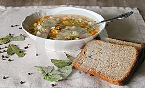 Russian Traditional cabbage, meat soup Shchi on white plate on natural wooden table background