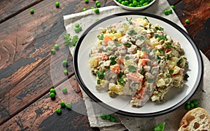 Russian traditional salad Olivier with vegetables and meat