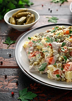 Russian traditional salad Olivier with vegetables and meat