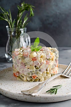 Russian traditional salad Olivier with vegetables and meat