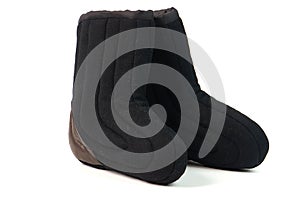 Russian traditional winter black boots-burki  on white background. Warm shoes for the elderly