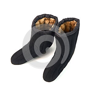 Russian traditional winter black boots-burki  on white background. Warm shoes for the elderly
