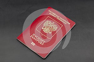 Russian travel passport on a black background, sanctions, emigration, immigration, tourism concept photo