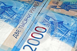 Russian two thousandth notes close-up against the background of a dark wooden table