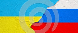 Russian and Ukraine flags on concrete texture wall background
