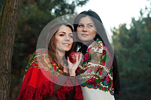 Russian village girls in headscarves in a dense forest