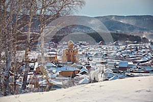 Russian village winter. Roofs covered with snow, a Blizzard sweeps in the forest