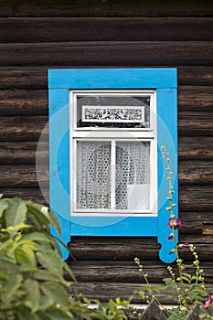 Windows with carved frames and shutters in village houses photo