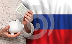 Russian woman with money bank on the background of Russia flag. Dotations, pension fund, poverty, wealth, retirement concept