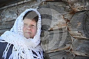 The Russian woman in shawl warms hands near an