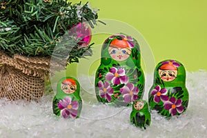 Russian wooden dolls with snow and Christmas tree