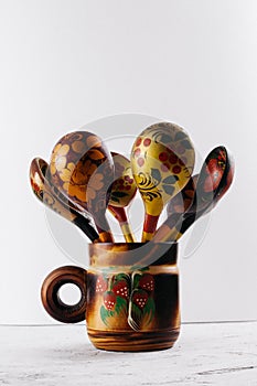 Russian wooden painted tableware: spoons in a mug