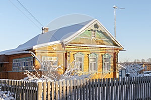 RussiaOld rural wooden house in russian village in winter sunny day. Moskow region, Russia