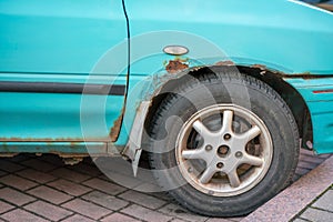 Rust on bodywork of old blue car