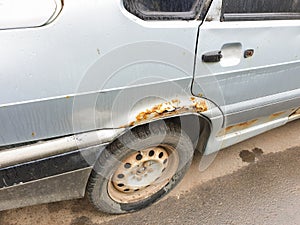Rust on the car body, cosmetic car repair from rust, metal corrosion