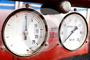 Rust and dirt on a pressure gauge and compound gauge to a old fire truck.