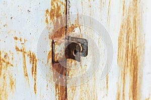 Rust.Fragment of a rusty metal door.Rusty hinges for the lock