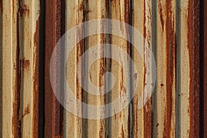 Rust on the gland. Corrugated iron sheet with peeling yellow paint. Texture and background. Yellow red