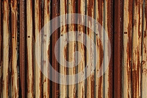 Rust on the gland. Corrugated iron sheet with peeling yellow paint. Texture and background. Yellow red