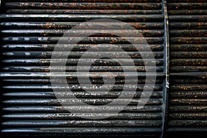 Rust steel tubes of the heat exchanger for maintenance, the water heater in the boiler as background