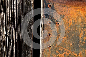 Rust texture. Grunge rusted metal, nails and older wood plank, rust and oxidised metal background. Old metal iron panel.