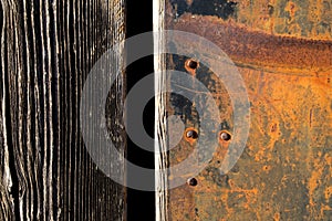 Rust texture. Grunge rusted metal, nails and older wood plank, rust and oxidised metal background. Old metal iron panel.