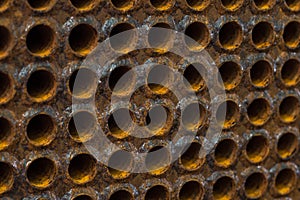 Rust tube sheet of the heat exchanger for maintenance in fabrication, the water heater in the boiler as background