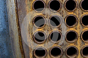 Rust tube sheet of the heat exchanger for maintenance, the water heater in the boiler as background