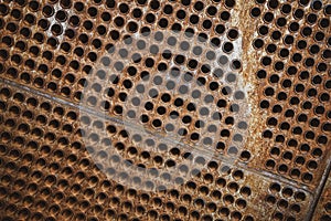 Rust tube sheet of the heat exchanger for maintenance, the water heater in the boiler as background