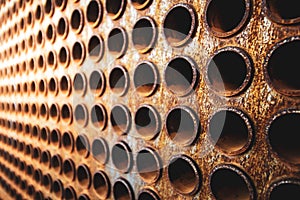 Rust tube sheet of the heat exchanger for maintenance, the water heater in the boiler as background wirh light photo