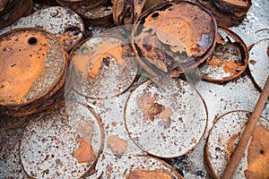 Rusted barrels on the shore.