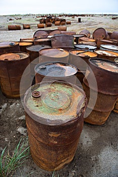 Rusted barrels on the shore, Chukotka, Russia photo
