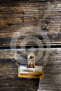 Rusted binder clip on weathered wood boards