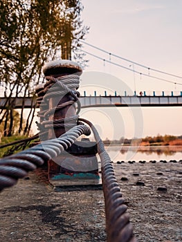Rusted bollard rope in harbor