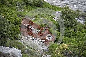 Rusted car at the bottom of the ravine